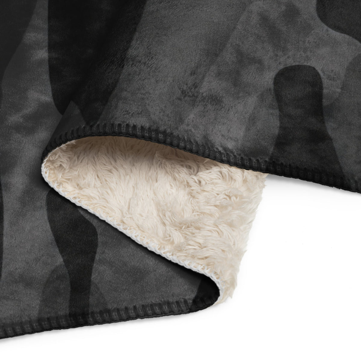 Black camo blanket fleece with black and gray camouflage pattern and plush cream sherpa lining for warmth