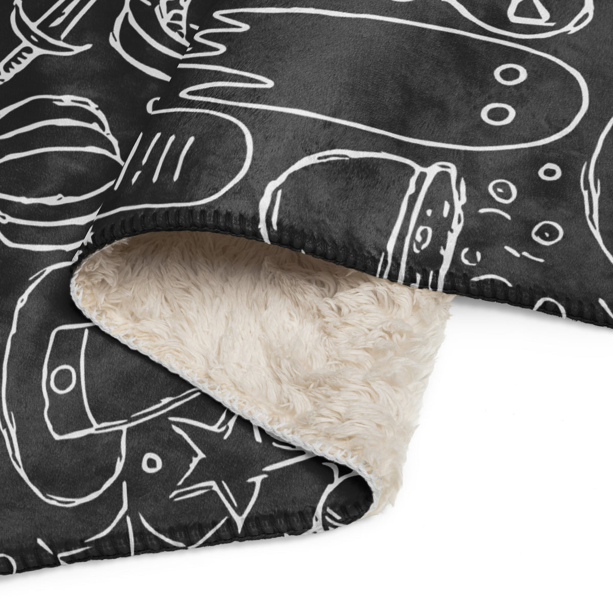 Black halloween blanket with white chalk-style food doodles and cream sherpa lining soft plush material