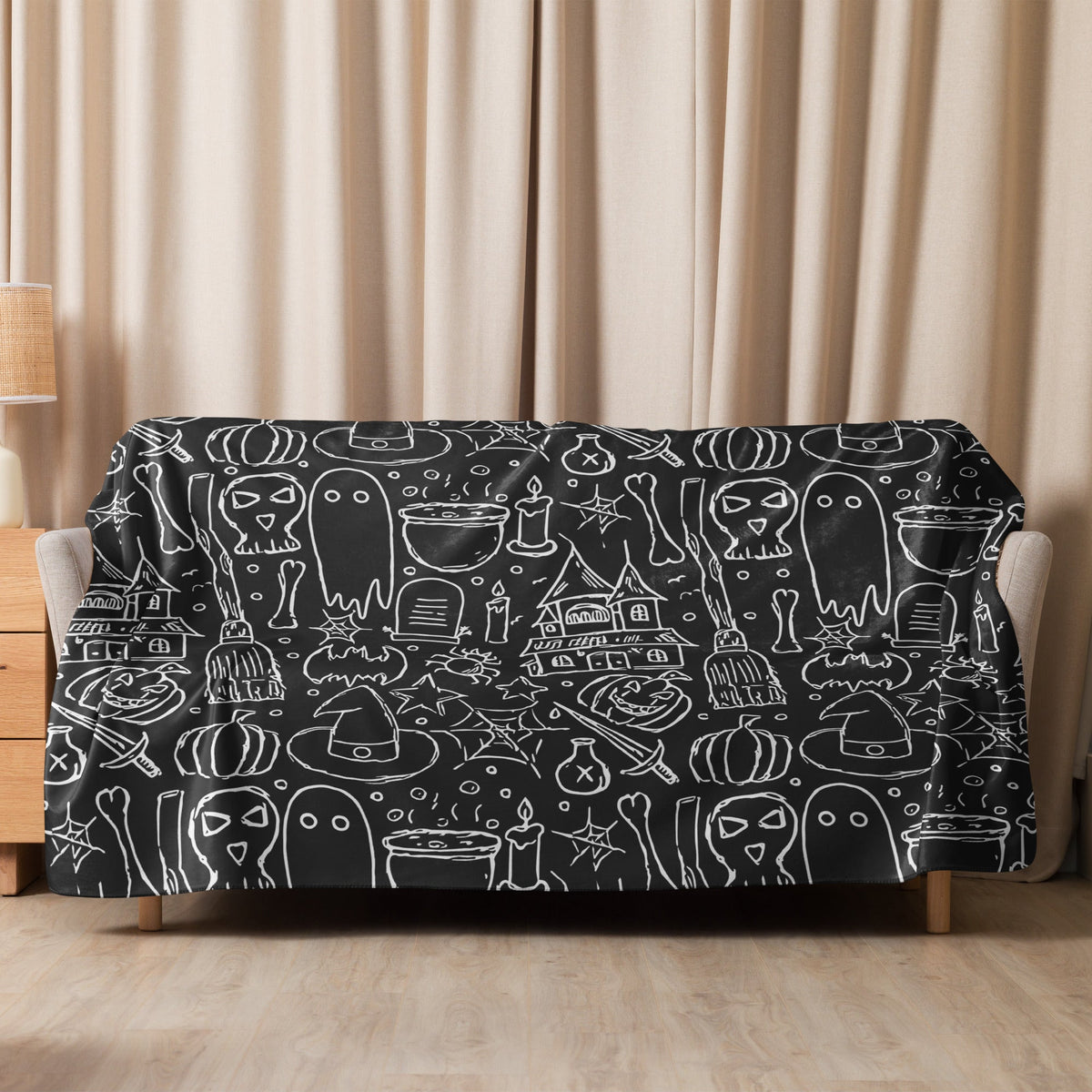 Black halloween blanket made of soft fabric with white chalk style halloween illustrations on black background