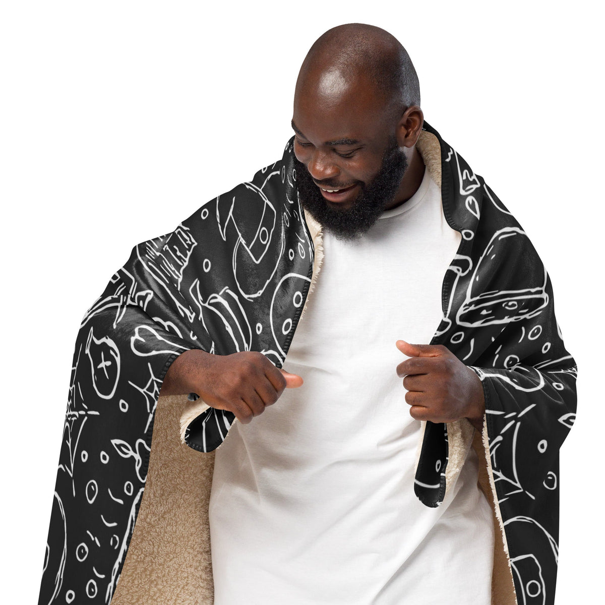 Black halloween blanket with white food line drawings and plush beige fleece lining for cozy warmth