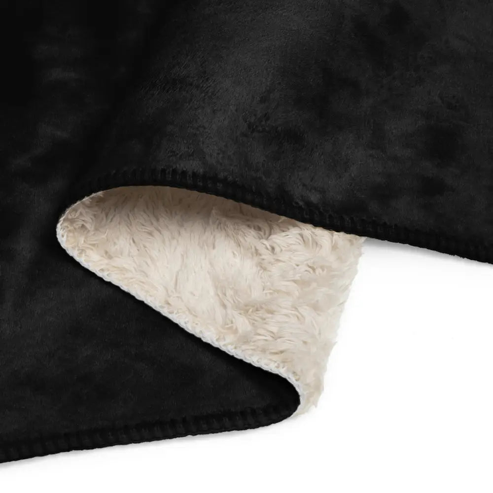 Black Sherpa blanket with a soft cream-colored fleece interior and plush black exterior for cozy warmth
