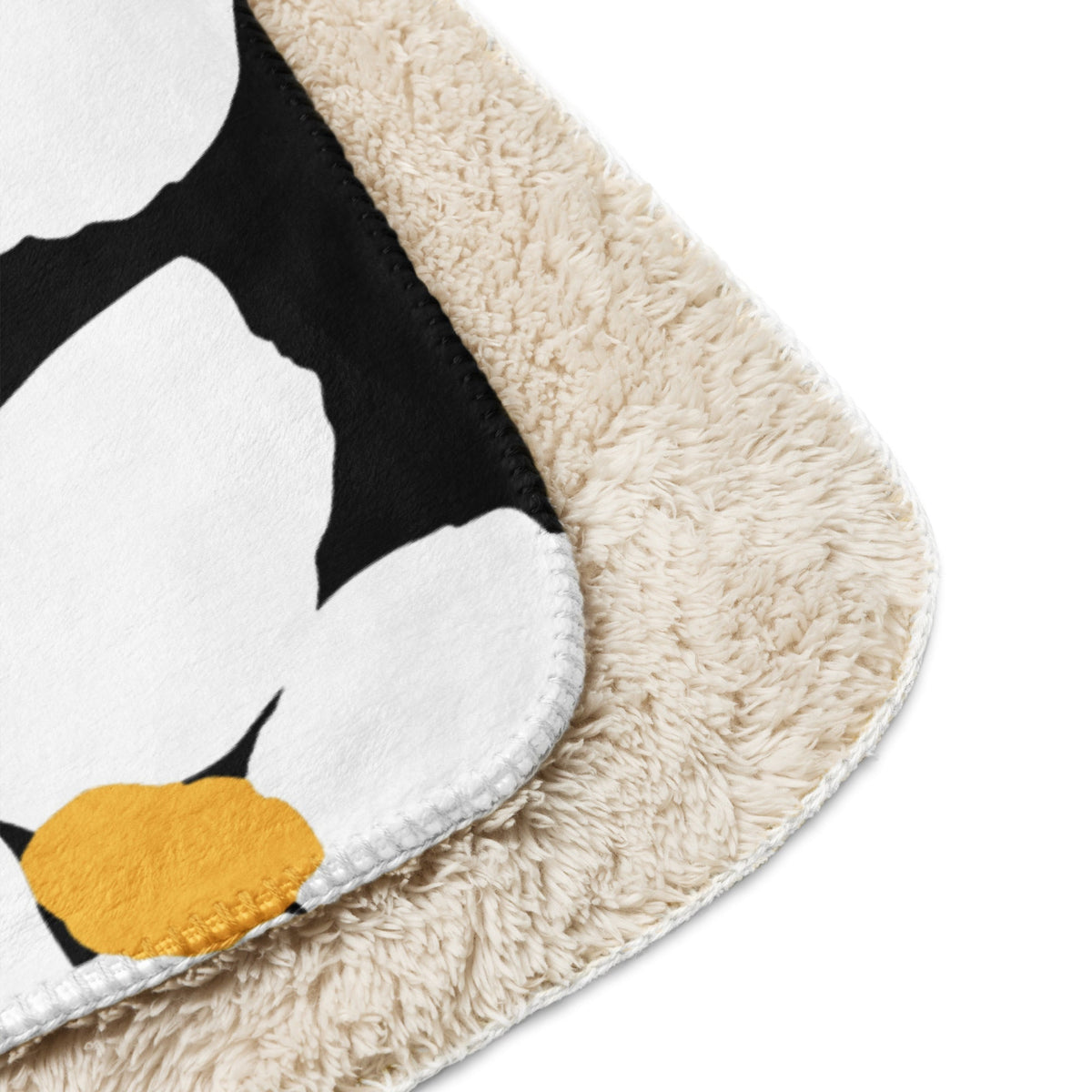 Cream-colored plush Black and White Floral Blanket featuring a black and white penguin design with a yellow beak
