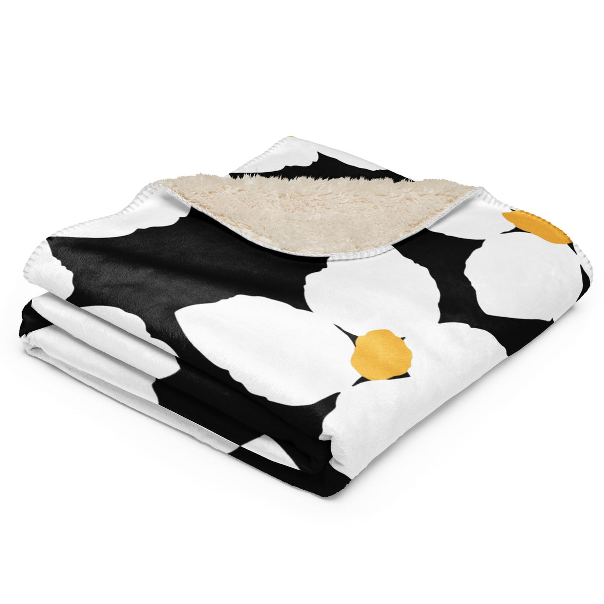 Black and white floral blanket with yellow centers featuring a cozy plush beige sherpa lining
