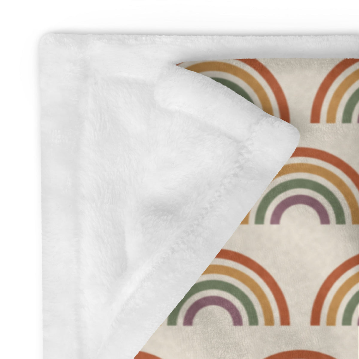 Boho rainbow throw blanket in cream with a retro warm-tone rainbow pattern and plush white interior for cozy use