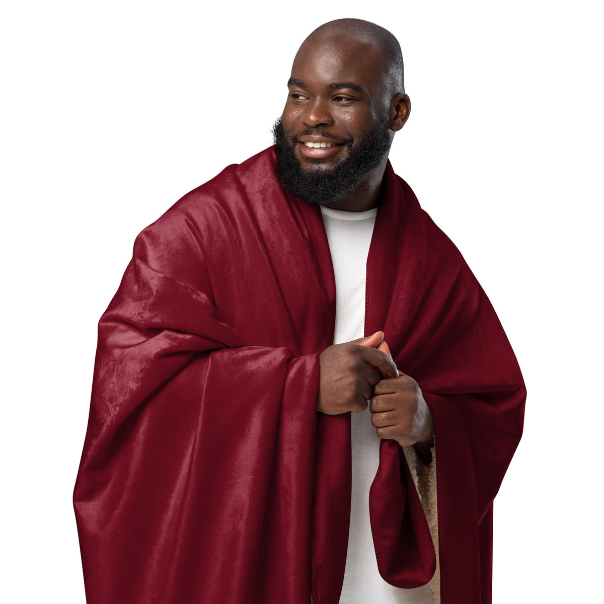 A rich burgundy sherpa blanket draped over a man’s shoulders with soft folds and a luxurious satin sheen