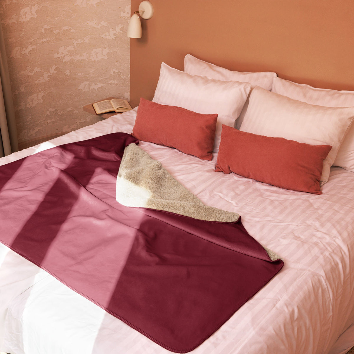A plush burgundy sherpa blanket with a two toned design featuring a soft beige fleece interior for cozy warmth