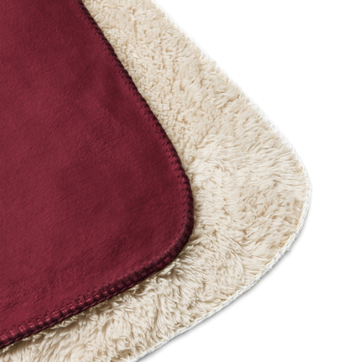 A plush burgundy sherpa blanket with a suede-like outer surface and a soft cream sherpa interior