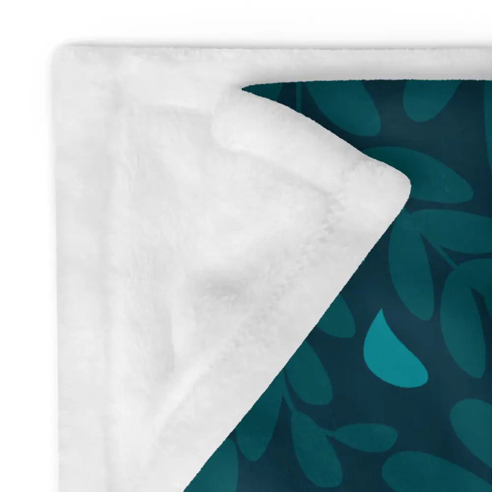 Christmas ornament blanket with teal leaf pattern plush side and soft white fleece lining for cozy warmth