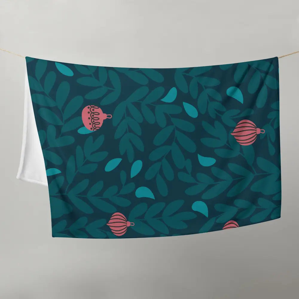 A teal christmas ornament blanket with pink ornaments and green leaves pattern perfect for holiday decor