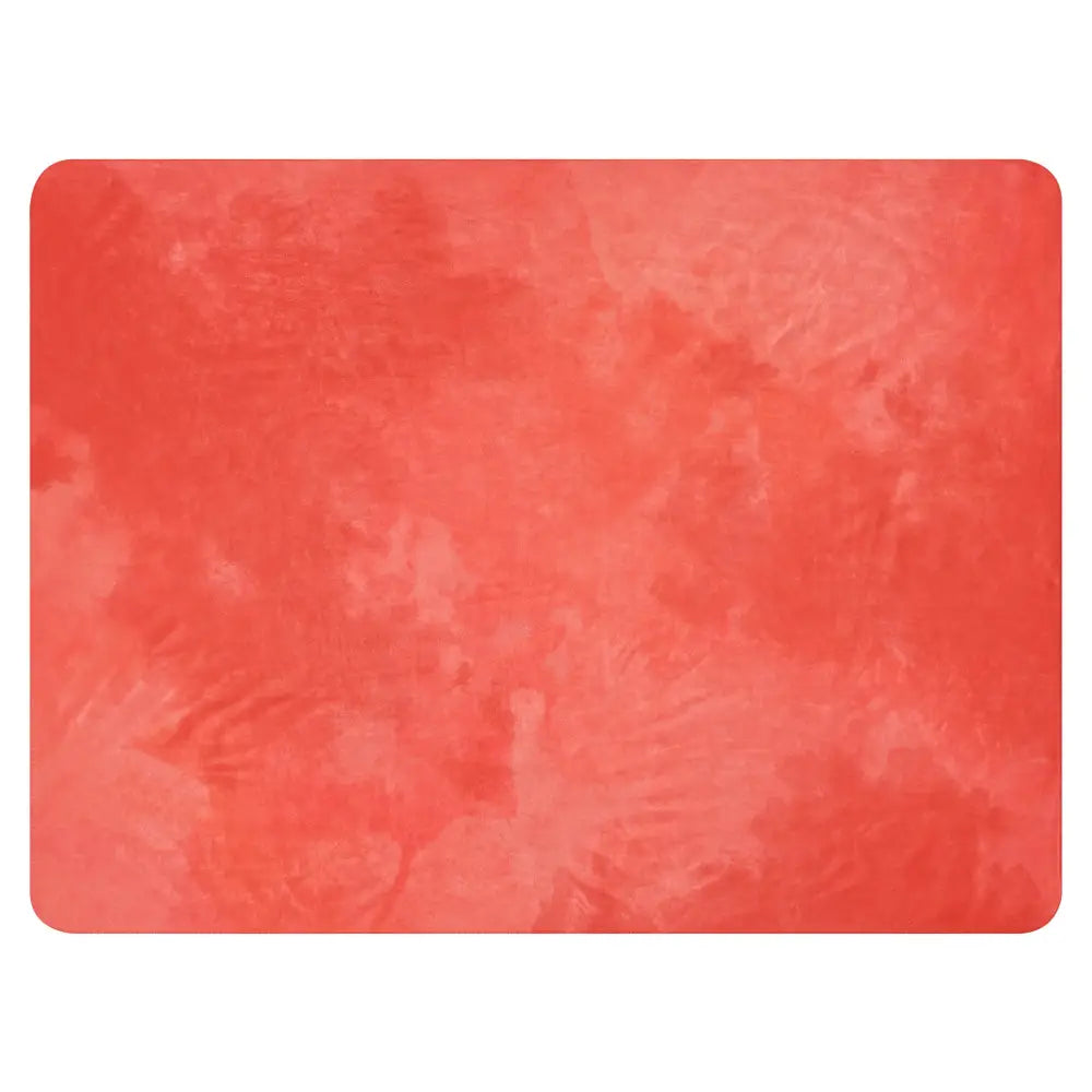 Coral sherpa blanket with a rectangular coral-colored textured watercolor-like surface and soft material