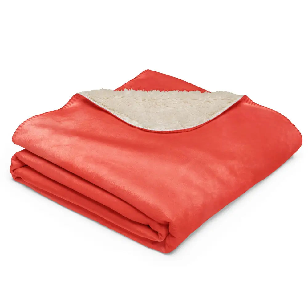A cozy coral sherpa blanket with plush cream fleece lining perfect for warmth and comfort