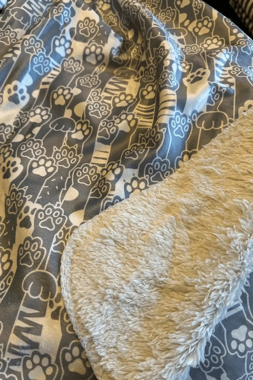 Gray and white cat-themed blanket with a plush, cream-colored fleece interior.