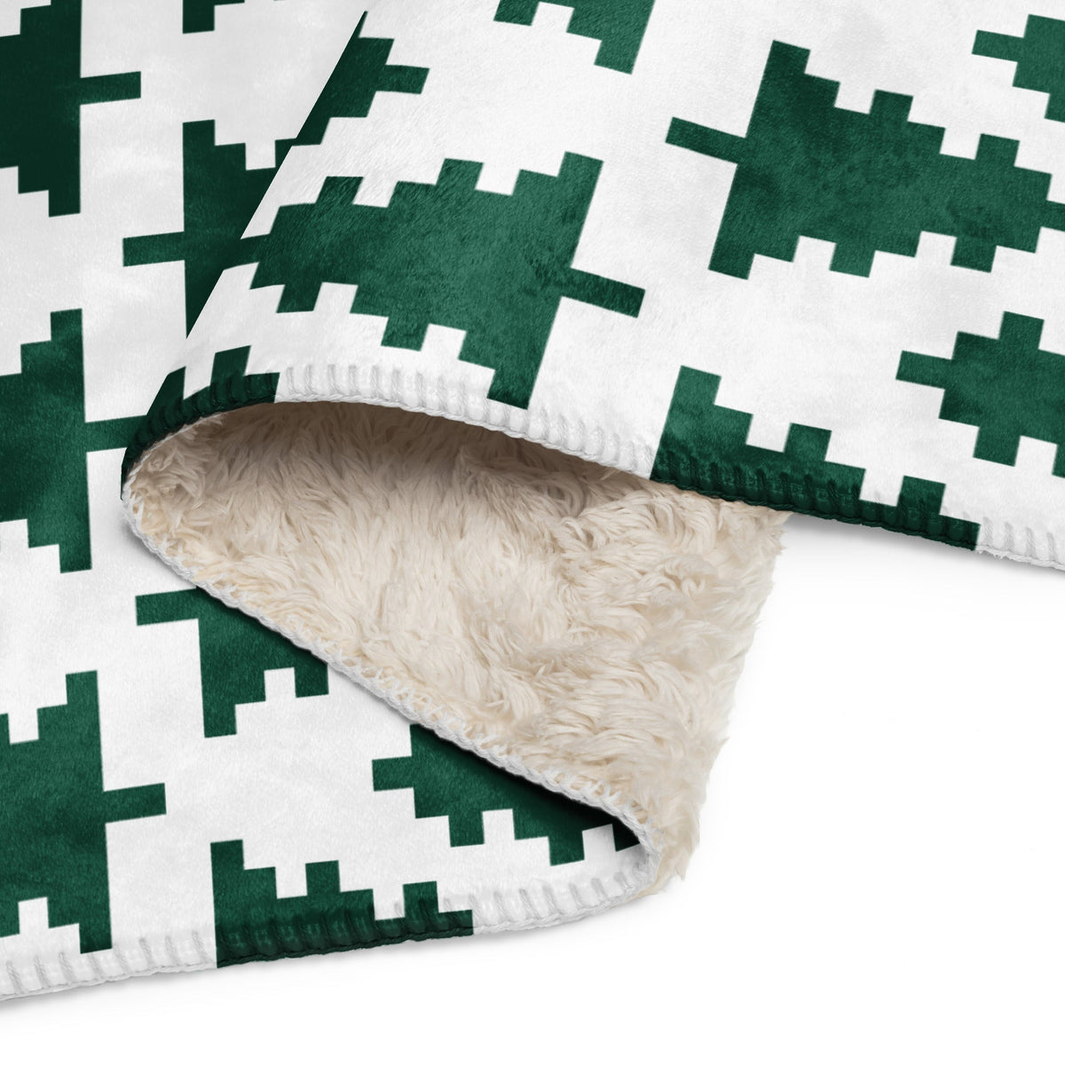 Green and white christmas blanket with pixelated houndstooth pattern plush exterior and beige sherpa lining