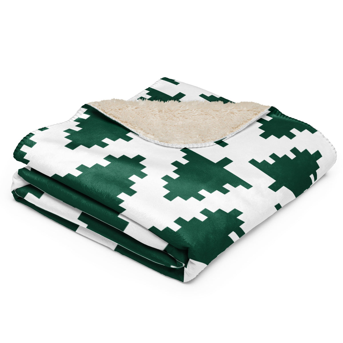 A cozy green and white Christmas blanket with pixelated tree pattern and plush beige sherpa lining
