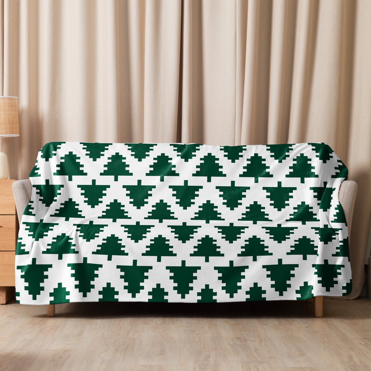 A cozy white Christmas blanket with a repeating pattern of dark green pixelated Christmas trees