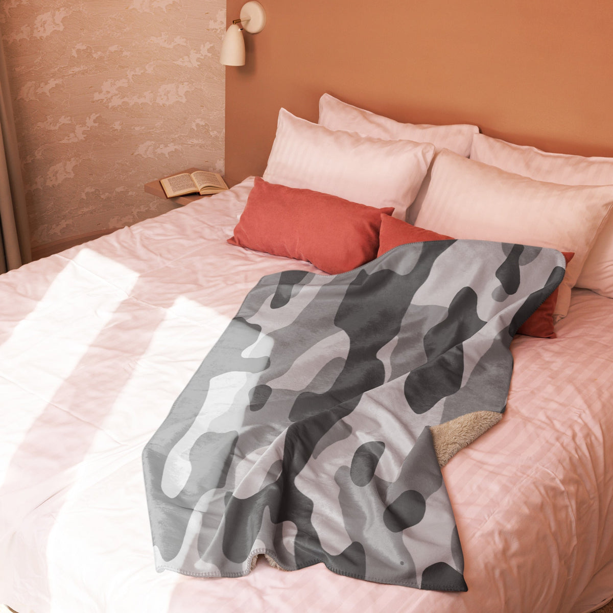 Grey camo blanket is a gray and black camouflage throw with a soft fleece-lined interior for cozy warmth