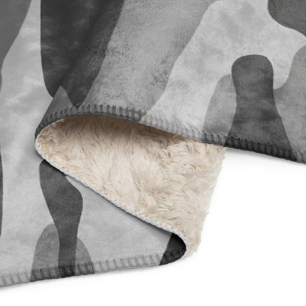 Grey camo blanket with gray and black camouflage fleece front and plush cream sherpa lining for warmth and comfort