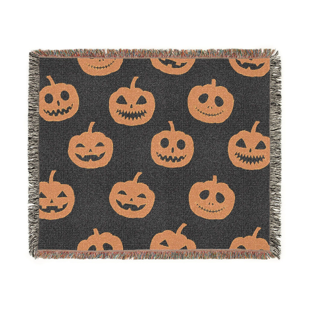 Black woven throw blanket with orange jack o lantern faces and fringed edges for halloween decor