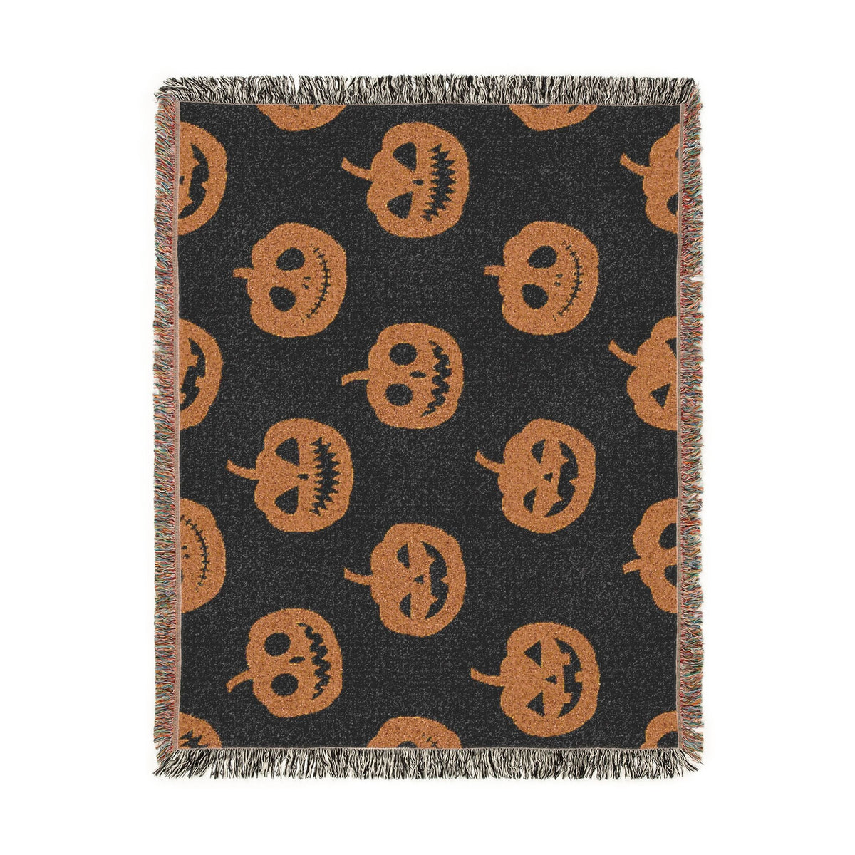 Black woven Halloween blanket with orange jack-o-lantern pattern and fringed edges for seasonal decor