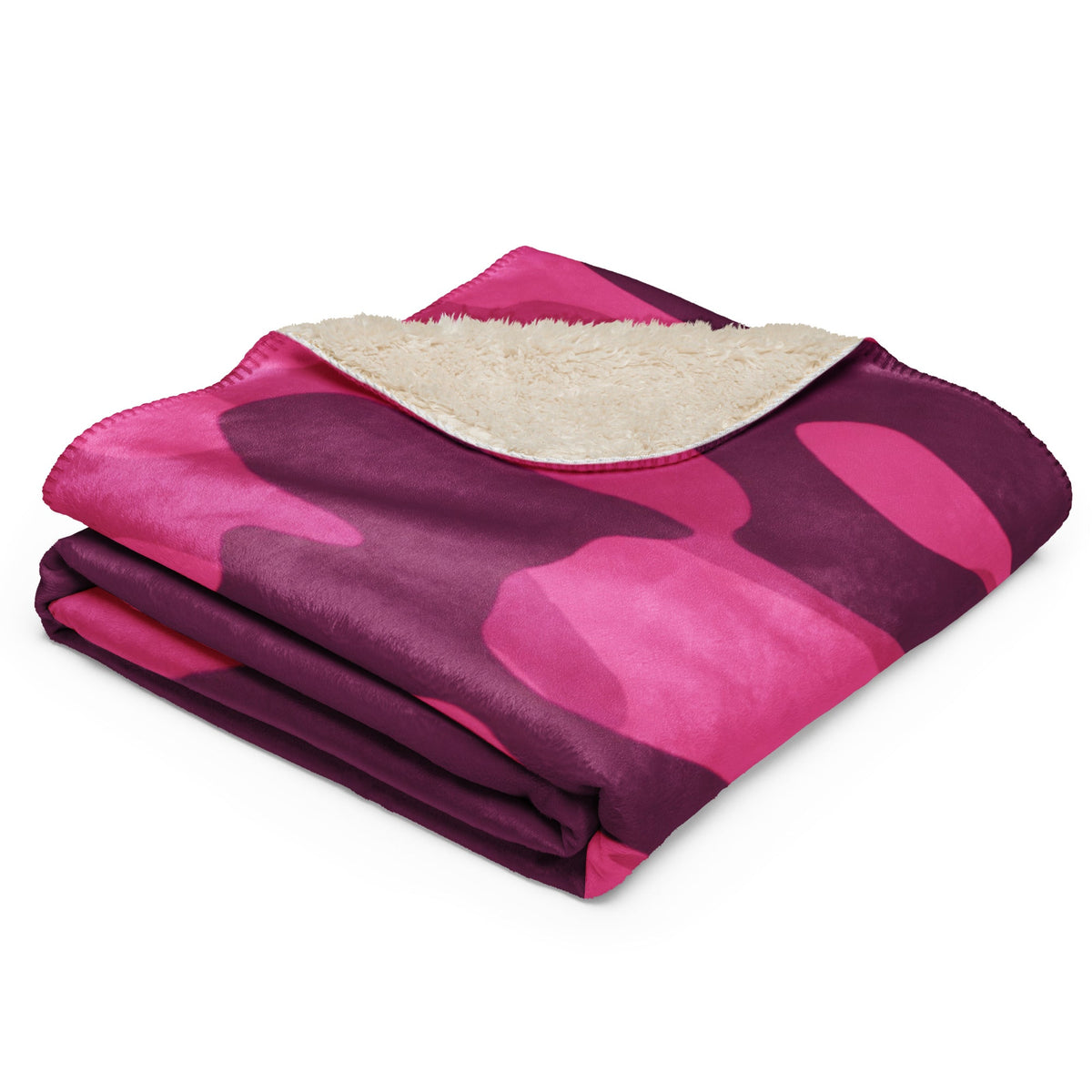 A cozy hot pink camo blanket with plush cream sherpa lining featuring a pink and purple camouflage pattern