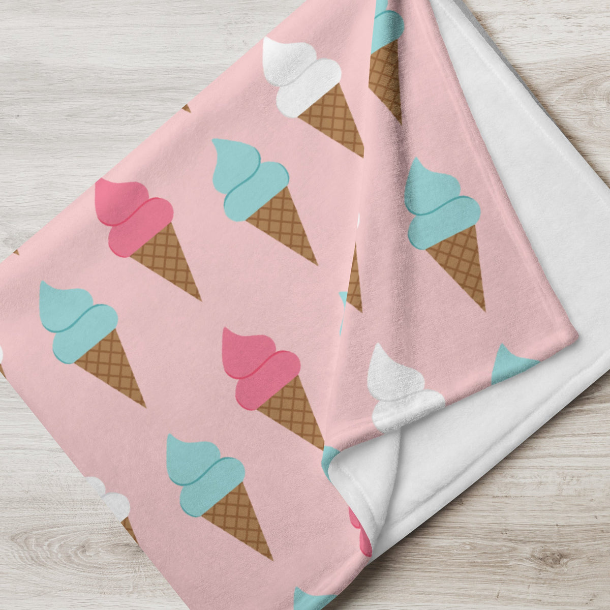 Pink ice cream cone blanket with a repeating pattern of cartoon cones in pink teal and white perfect for cozy use