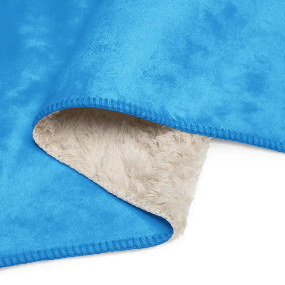 Light blue sherpa blanket with bright blue plush exterior and soft fluffy cream-colored interior lining