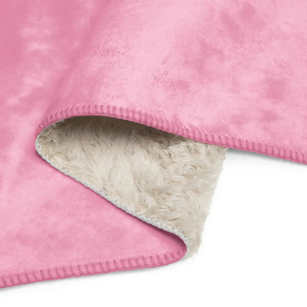 Light pink sherpa blanket with a soft fluffy white sherpa lining and stitched edges for cozy warmth