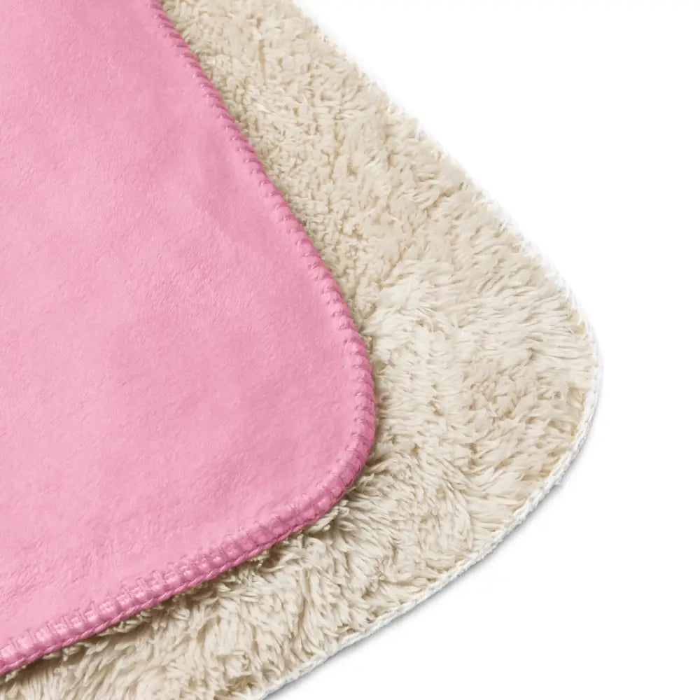 Light pink sherpa blanket with a soft fuzzy texture and neatly stitched edges for cozy warmth and comfort