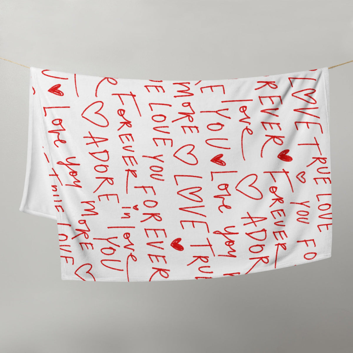 White love letter blanket featuring red handwritten romantic phrases and heart symbols on a soft fabric