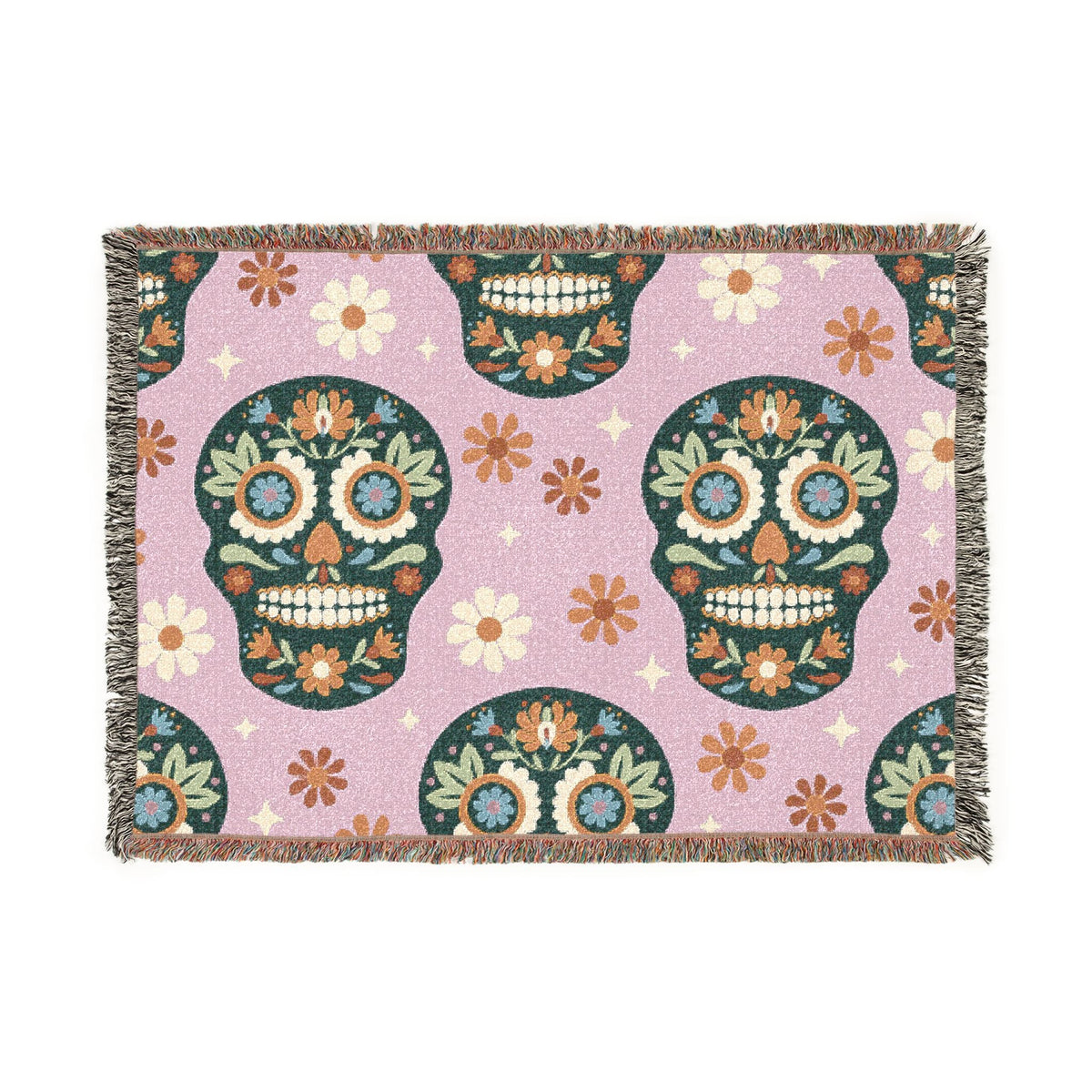 A rectangular woven mexican blanket with a soft lavender background featuring colorful sugar skull patterns