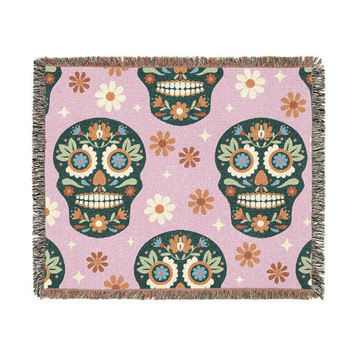 A pink Mexican woven blanket with colorful floral sugar skull patterns and green outlines and accents