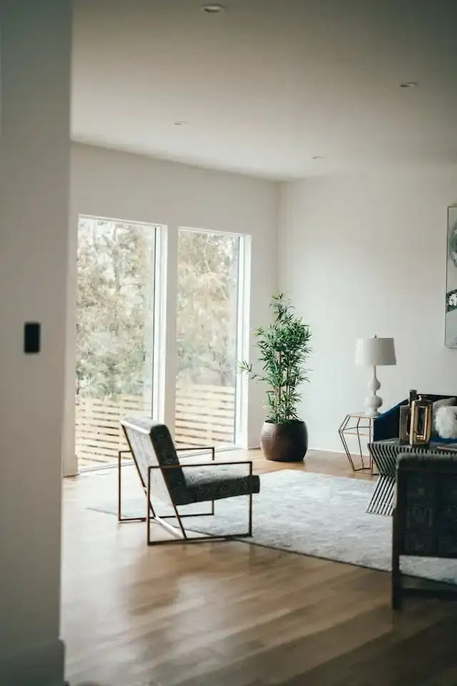 Modern black upholstered armchair with slender metal frame.