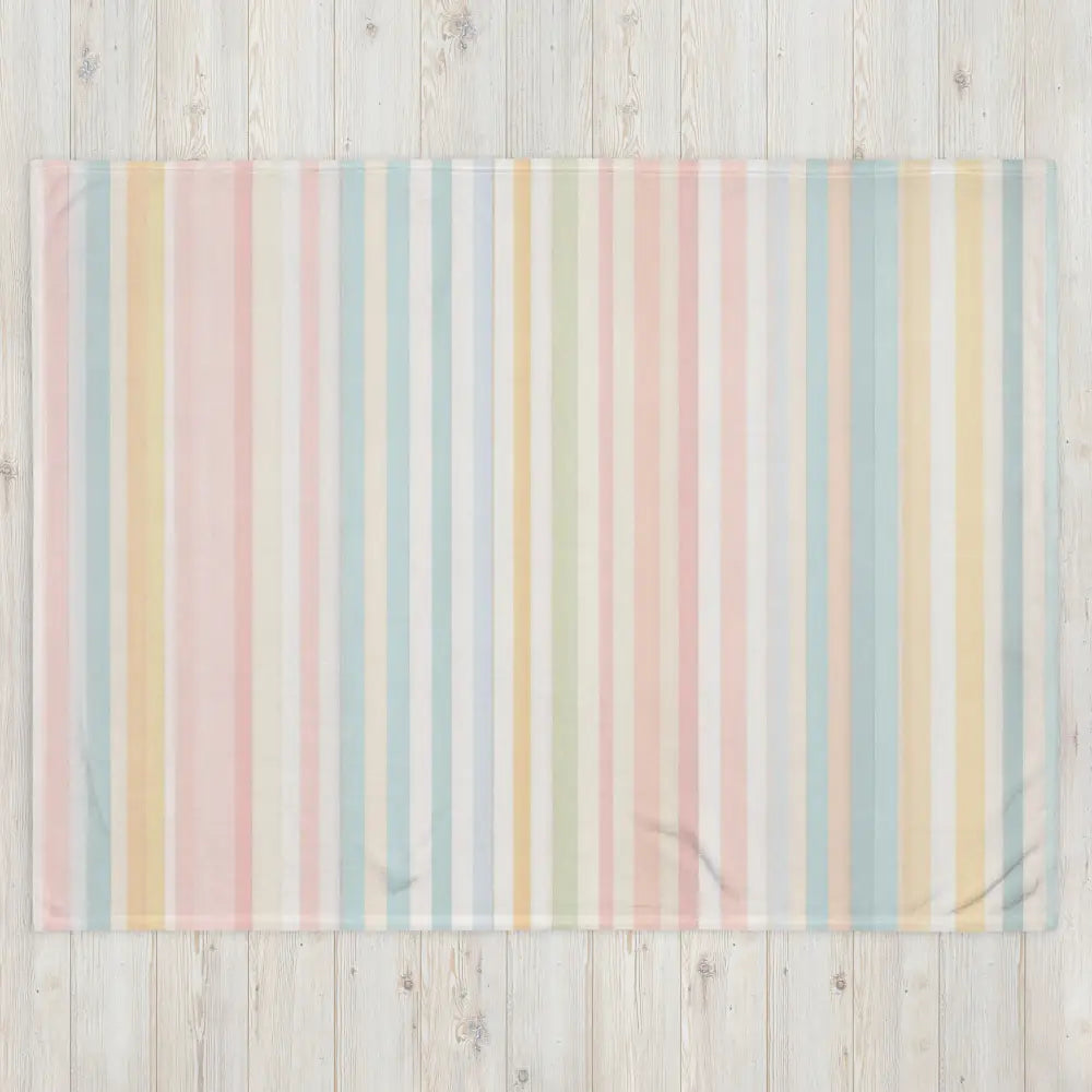 Couverture en laine multicolore à rayures pastel verticales en rose bleu jaune et blanc pour un usage cocooning