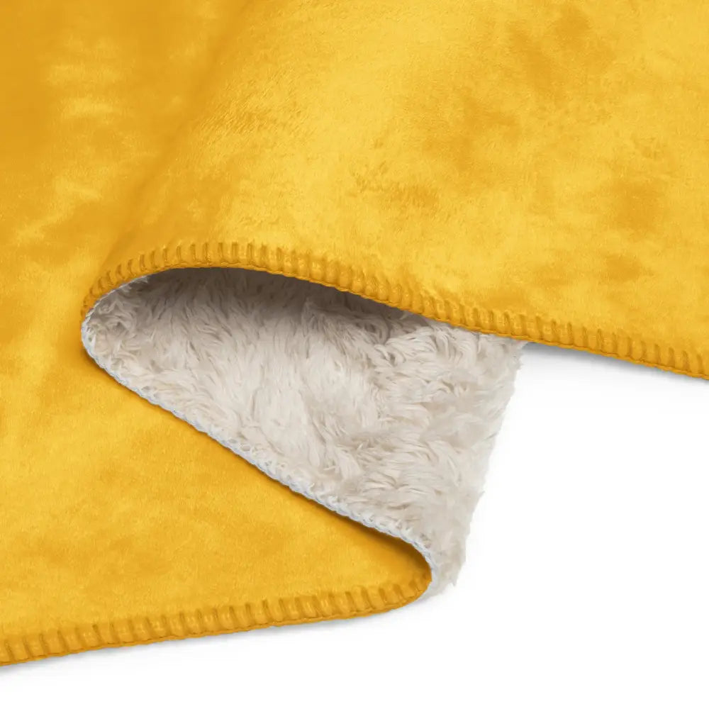 Mustard sherpa blanket featuring a plush mustard yellow fleece with soft white sherpa lining and stitched edges