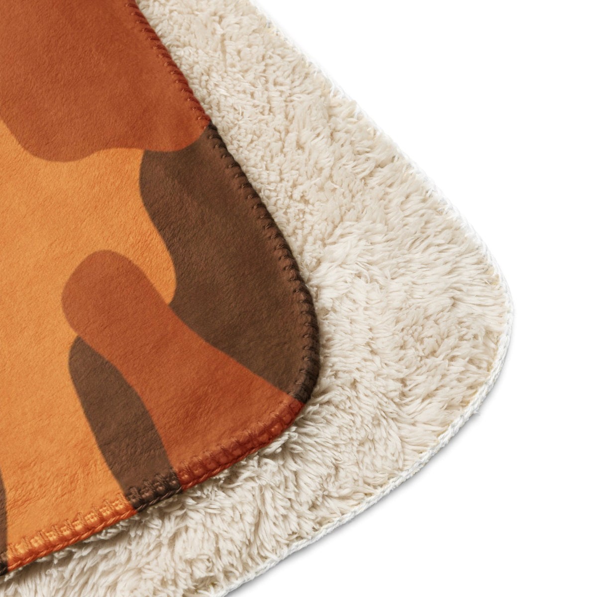 A cozy orange camo blanket with plush camouflage pattern and soft cream sherpa lining for warmth and comfort