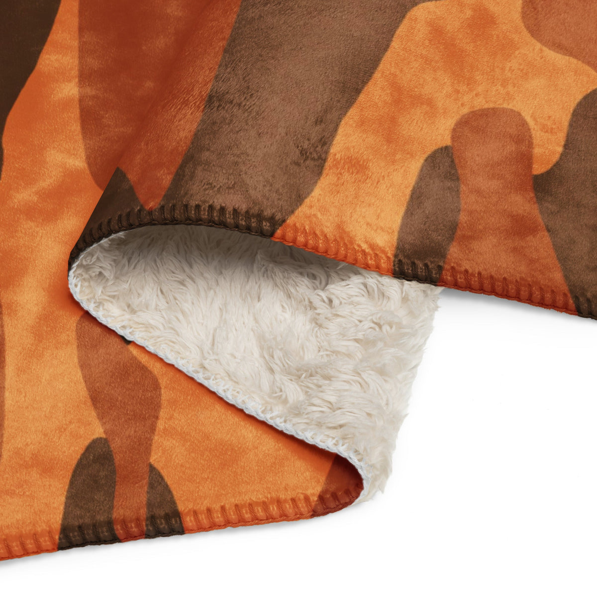 A cozy orange camo blanket with a brown camouflage pattern and plush white fleece interior for warmth