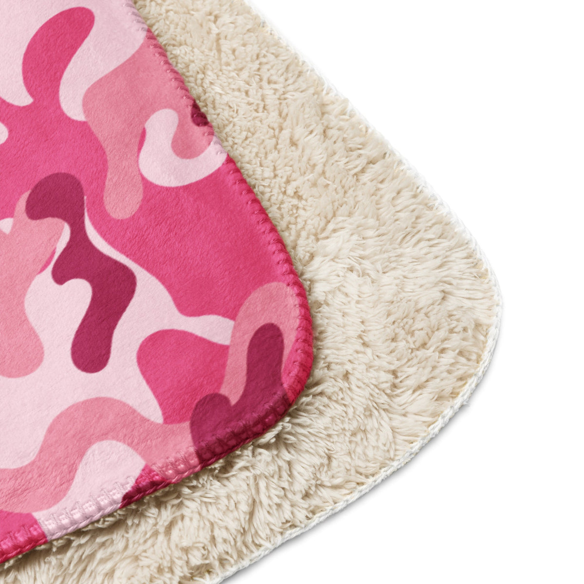 Pink camo blanket featuring a pink and white camouflage fleece with a plush cream sherpa lining for warmth