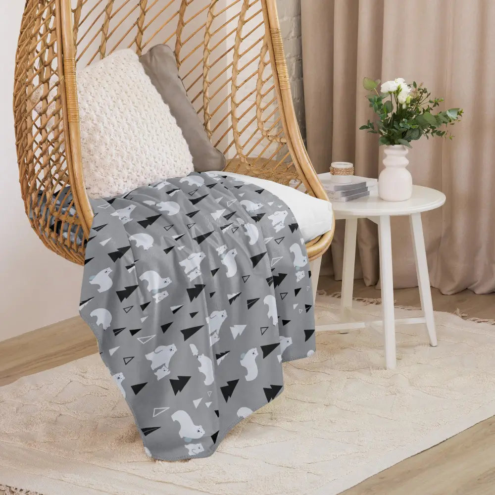 Gray polar bear sherpa blanket featuring a playful pattern of white and black geometric shapes and stylized animals
