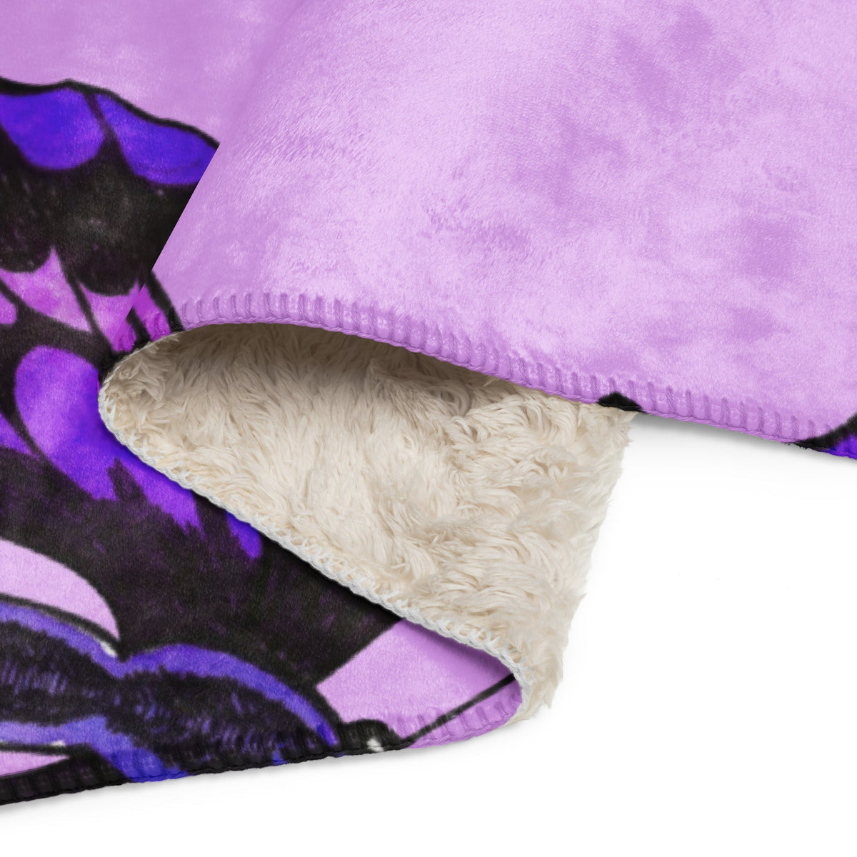 Purple butterfly blanket featuring a purple and black floral fleece front and plush cream sherpa lining for warmth