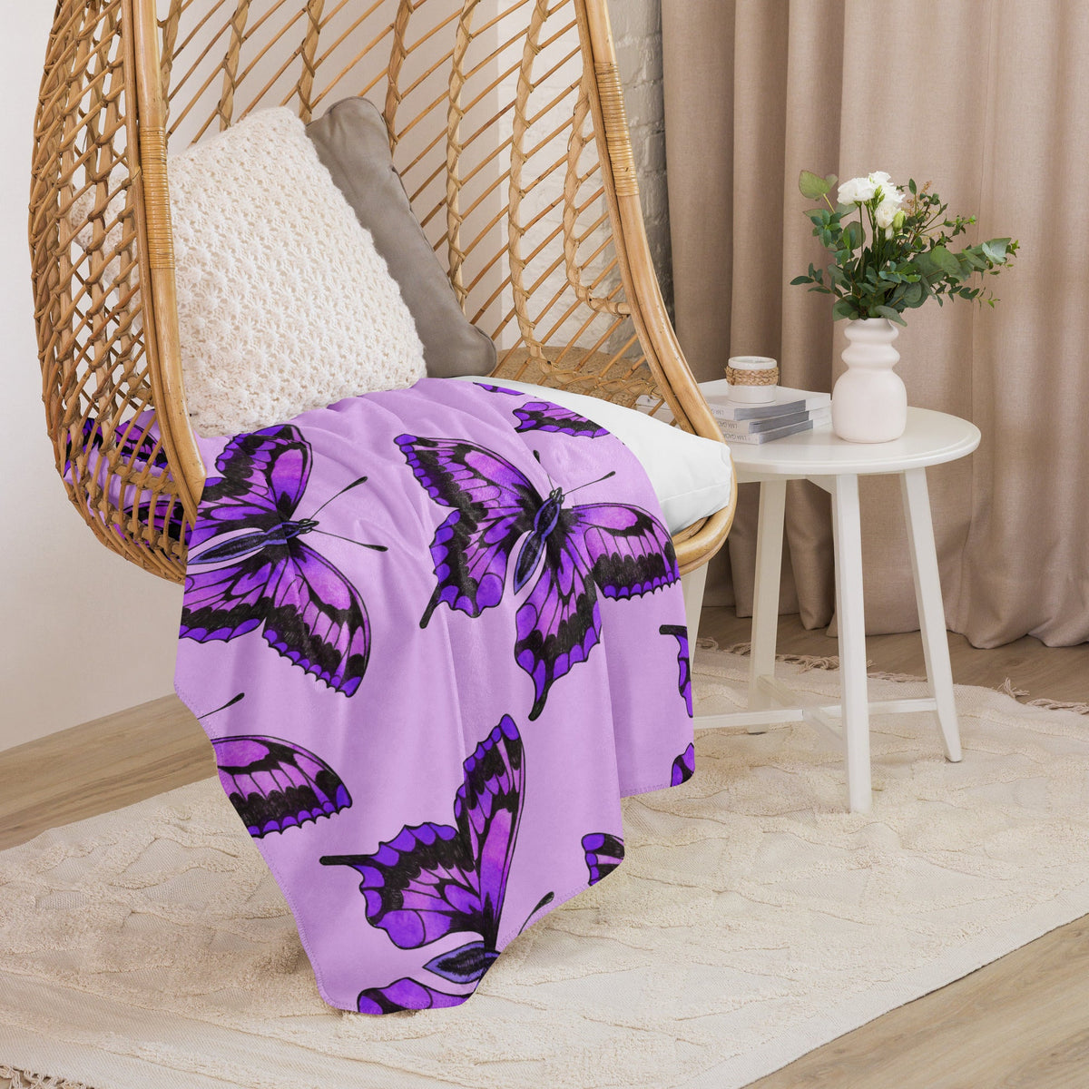 Purple butterfly blanket featuring a purple throw blanket with black outlined butterfly patterns