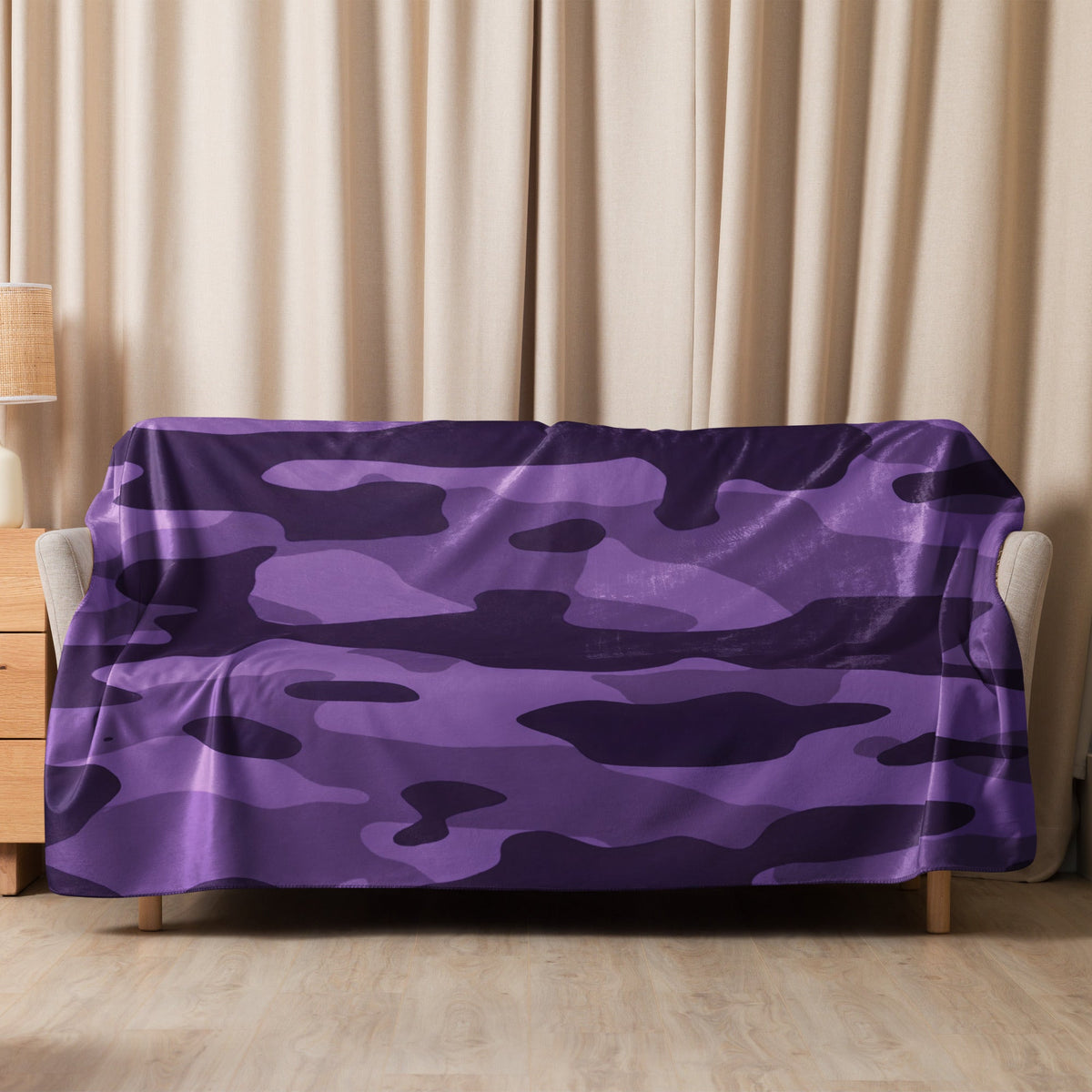 Purple camo throw blanket featuring a soft camouflage pattern draped over a sofa for cozy home use