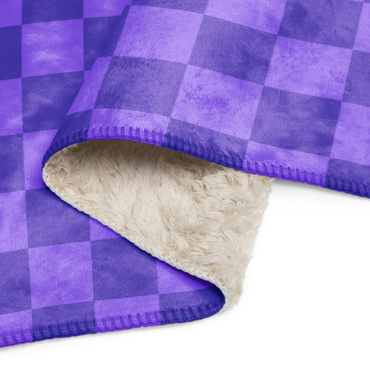 Purple checkered blanket with purple and navy blue plaid fleece and plush cream-colored sherpa lining