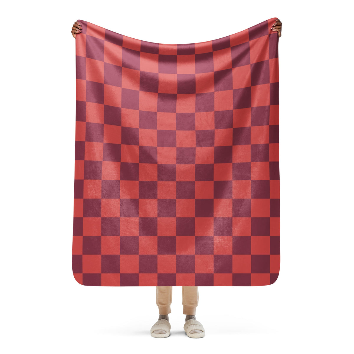 A soft plush red checkered clanket blanket featuring a bold red and maroon checkerboard pattern
