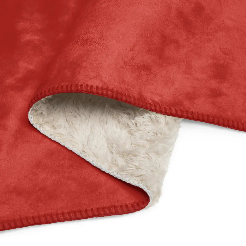 Red sherpa blanket with red faux suede exterior and plush white sherpa lining for cozy warmth