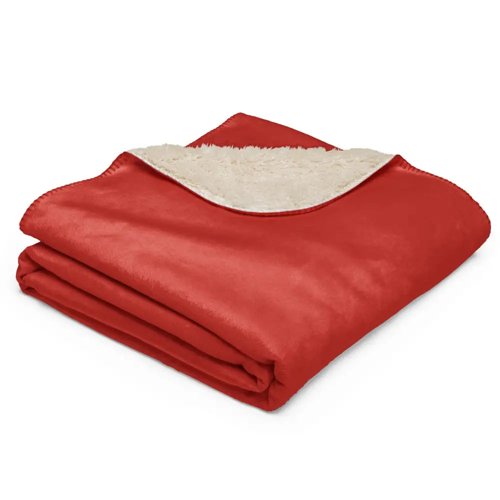 Red sherpa blanket with plush red exterior and cream-colored sherpa lining for warmth and comfort