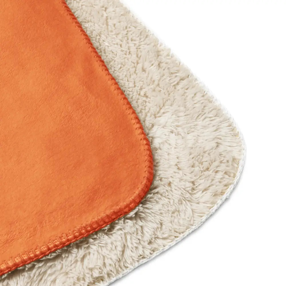 Orange and cream sherpa blanket with a soft plush textured surface for cozy warmth and comfort