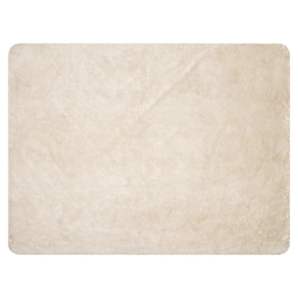 Cream-colored sherpa blanket with plush shaggy texture and soft fluffy feel featuring slightly rounded edges