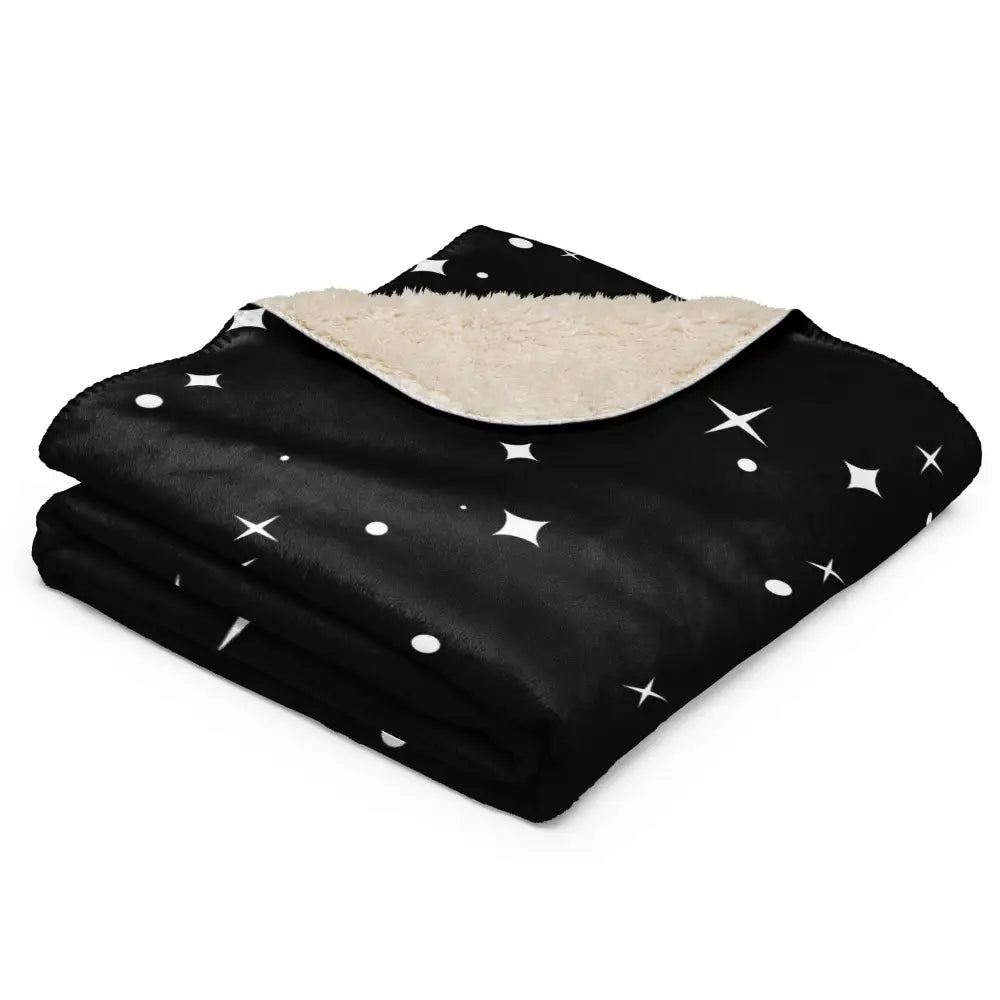 Black star sherpa blanket with white star and dot patterns and soft beige sherpa lining for cozy warmth