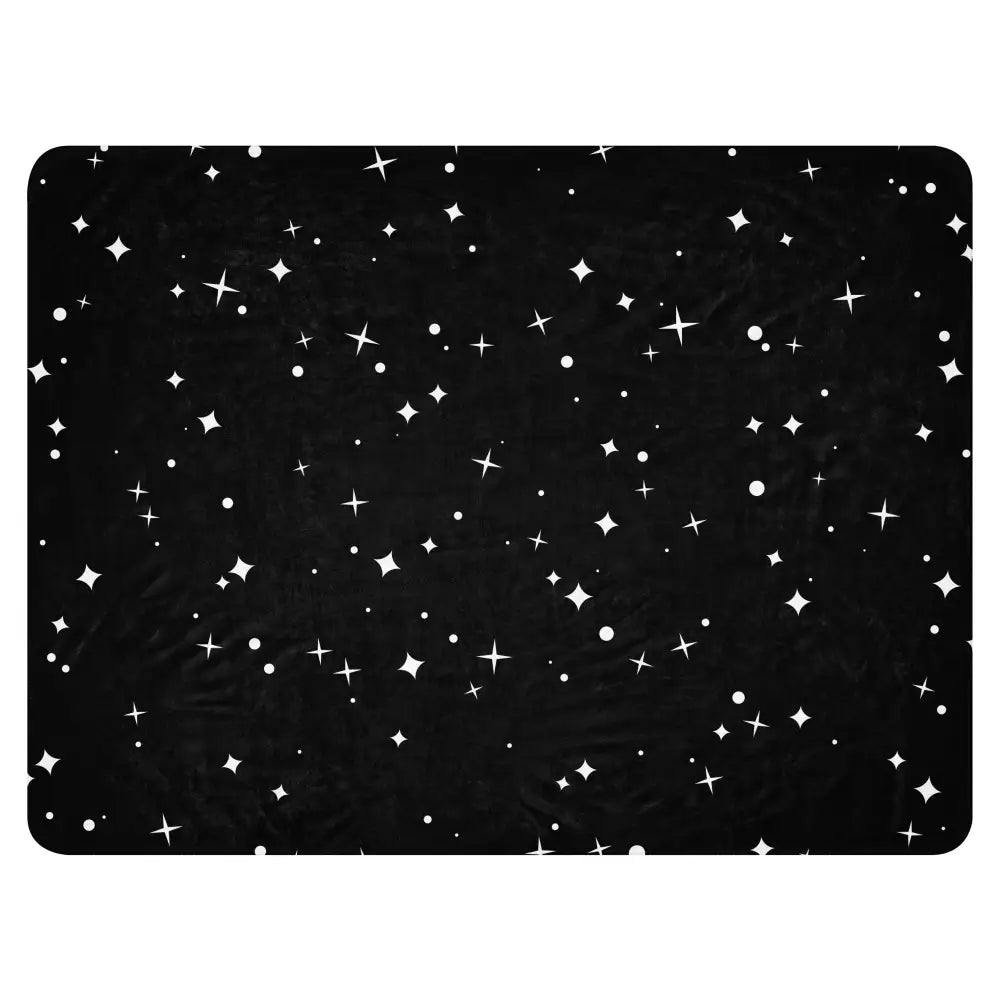 Black star-patterned sherpa blanket with white stars and dots on textured surface ideal for cozy use
