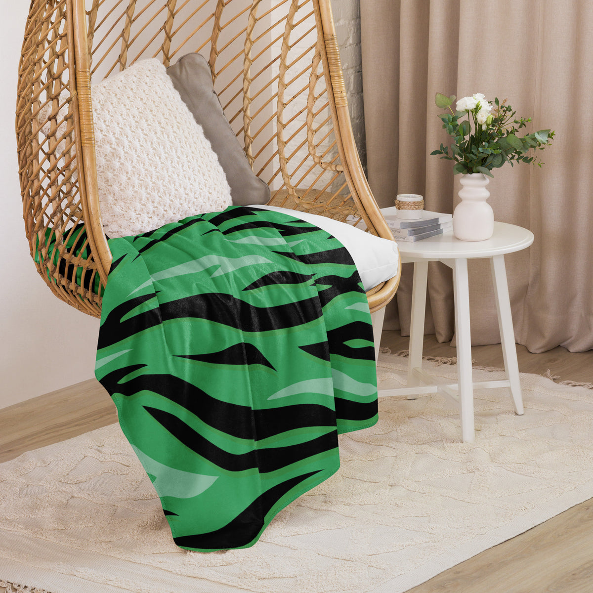 Green tiger blanket with vibrant green and black zebra stripes draped over a wicker hanging chair